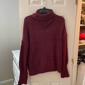 Red and white cable-knit turtleneck sweater